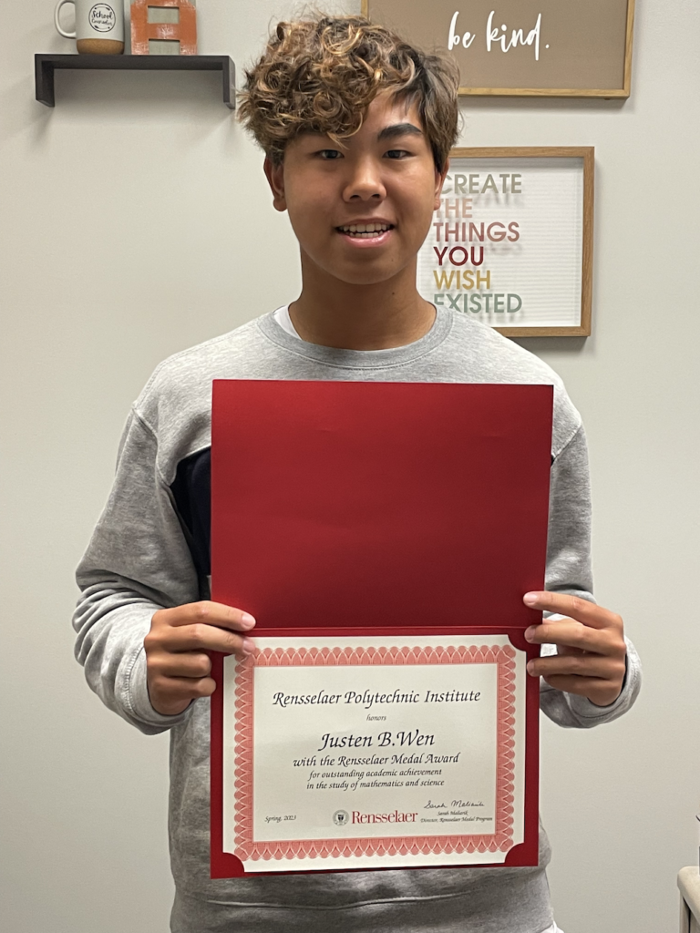 Middle Township High School Student holding a certificate for academic achievements and scholarship funding. 