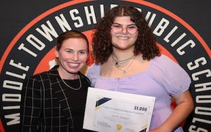 Middle Township High School Senior Kate DiGilio and Cooper Levenson attorney Kasi Marie Gifford pose for a photo as she is handed her scholarship certificate