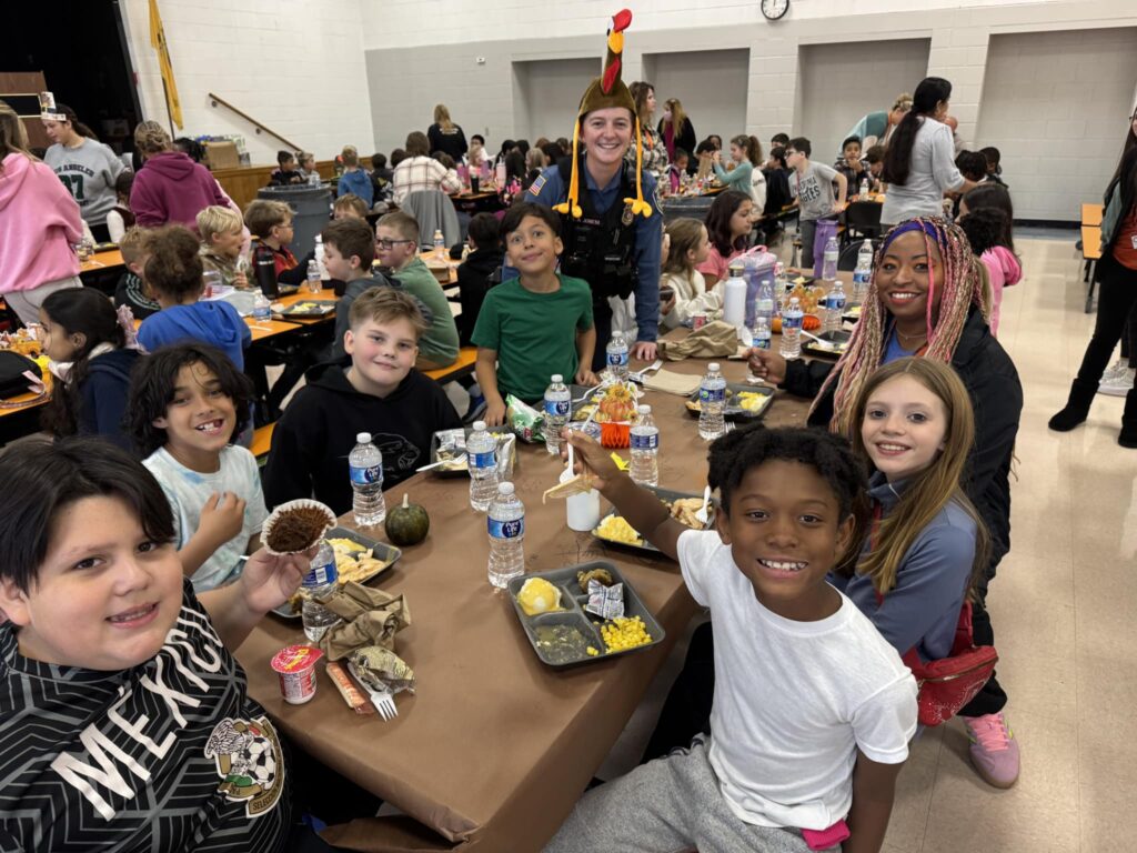 Miss Juliana Donohue’s fourth-grade class siting with Ms. Hines and Student Resource Officer Alyssa Jones 