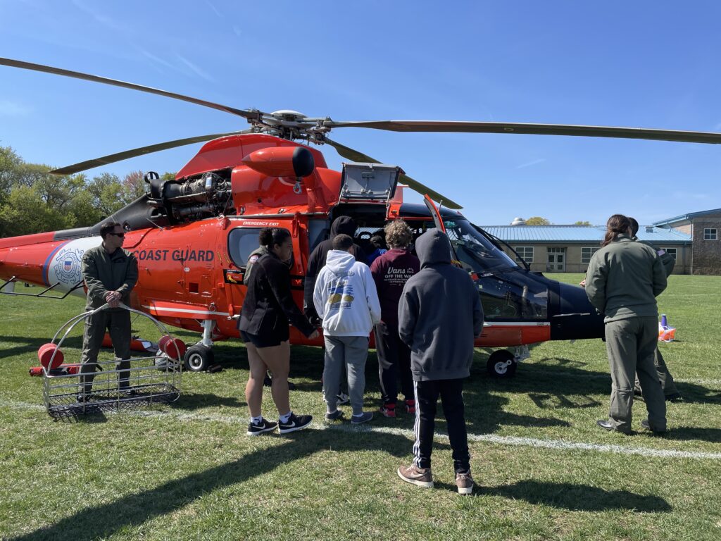 students surround US Coast Guard Helicopter 