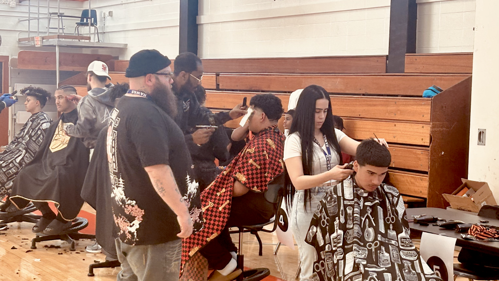 Students receive free haircuts and fades from local barbers and Cape May Technical School District cosmetologists. 