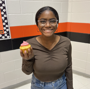 MTHS student holding a pink cupcake