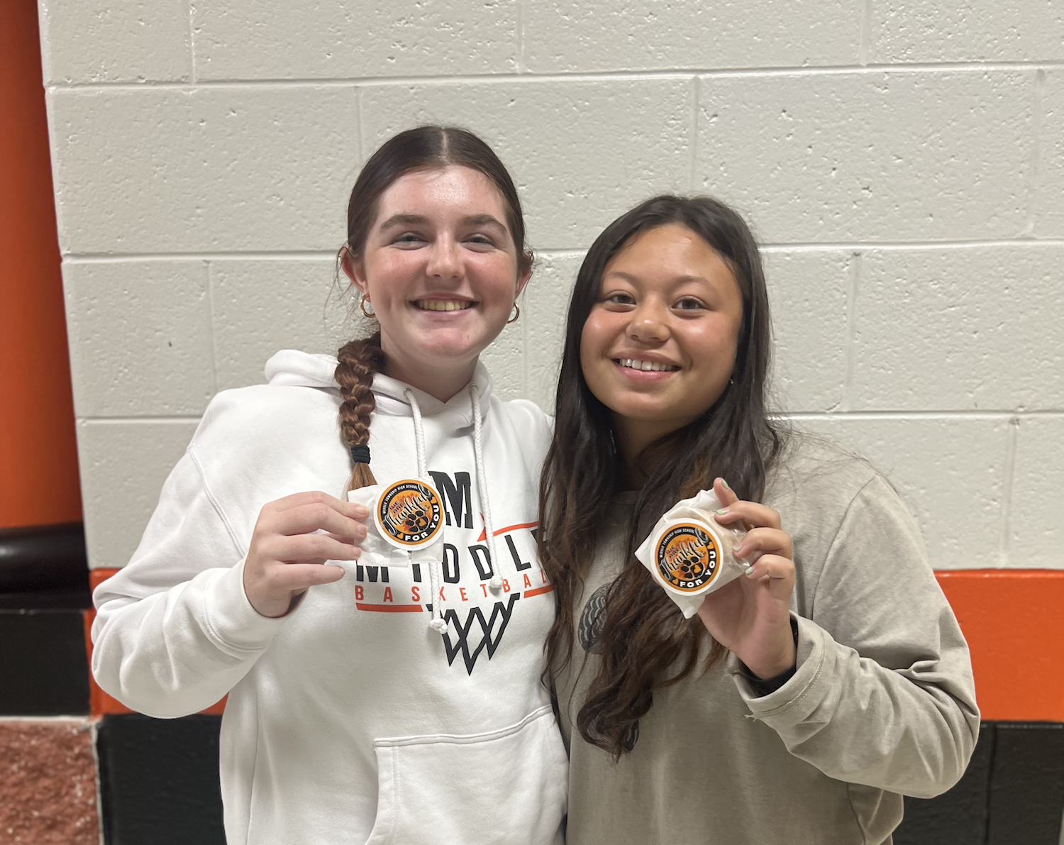 students holding stickers with middle township school district branding
