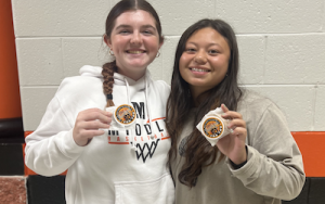 MTHS students Ella Leahy and Gabby Oliver posing with their desserts.