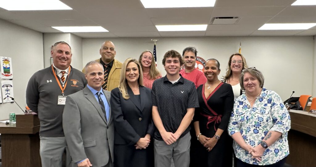 Stephanie DeRose, as well as her husband and son, standing with current members of the Middle Township Public Schools Board of Education. FRONT L-R: Quinn DeRose (husband), Stephanie DeRose, Anthony DeRose (son), Stephanie Thomas, and Claudia Miller BACK L-R: Dr. David Salvo, Burgess (Butch) Hamer, Cheryl McHale, Christopher Ingersoll, and Krista Ostrander