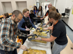 Volunteers Principal Carrie Sinone, Vice Principal Vincent Tridente, the School Resource Officer Alyssa Jones, Security Officer Jamie Loftus, custodian Barb Kardos, and MTHS students plating and delivering meals to students and staff. 