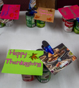 Donated food items and a Thanksgiving sign to be handed out during the holiday season