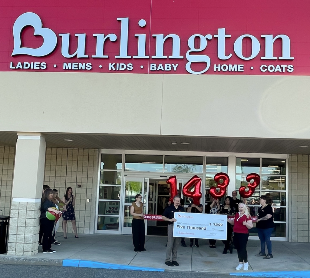 Burlington Store representatives and Middle Township Elementary #1 Principal Christian Paskalides hosting giant check in front of store ribbon cutting ceremony.