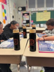 Students at Middle Township Elementary School #2 work with their new water bottles nearby. The bottles were donated through a partnership between Panthers in Action and Burke Subaru.