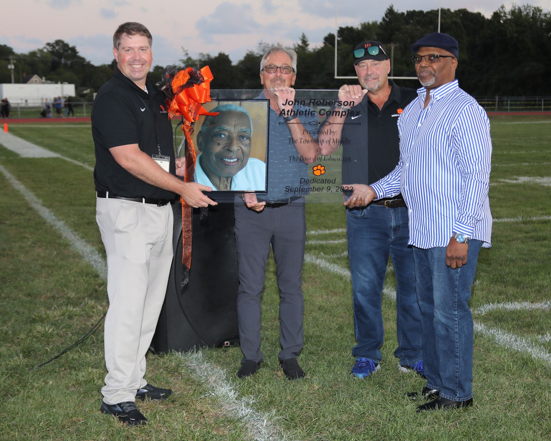 MTHS Principal George West, Middle Township Mayor Tim Donohue, Middle Township Board of Education President Dennis Roberts and Craig Roberson (son) holding dedication plaque. 